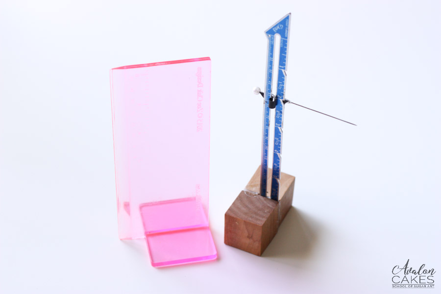 scraper, a sewing gauge with a needle, and a turntable extender