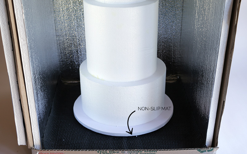 cake inside insulated box with a non-slip mat underneath 