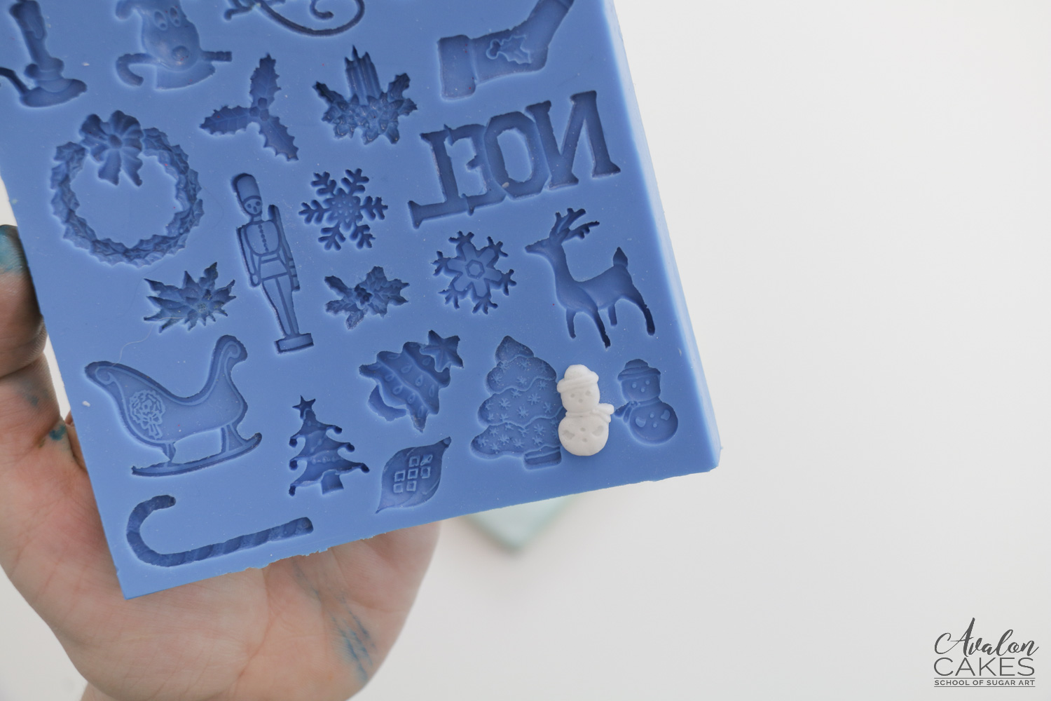 Christmas themed silicone mold with tiny fondant snowman 